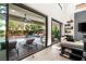 Bright, open living room with seamless indoor-outdoor flow, showcasing a modern fireplace and access to a private pool area at 80 Pristine Glen St, Las Vegas, NV 89135