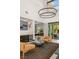 Bright living area with a modern chandelier, wet bar, and easy access to the outdoor patio and pool at 80 Pristine Glen St, Las Vegas, NV 89135