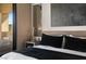Comfortable main bedroom features a wooden headboard, a slender mirror, and sliding doors leading to a patio at 80 Pristine Glen St, Las Vegas, NV 89135