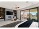 This gorgeous main bedroom boasts a fireplace, ceiling fan, and sliding glass doors to the outdoor patio at 80 Pristine Glen St, Las Vegas, NV 89135
