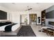 Serene main bedroom with a modern fireplace, TV, and a view of the ensuite and walk-in closet at 80 Pristine Glen St, Las Vegas, NV 89135
