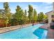 Beautiful backyard pool with stone accents, lush landscaping and tranquil water feature at 80 Pristine Glen St, Las Vegas, NV 89135