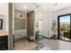 This modern shower features a glass enclosure, a pebble floor, and sleek fixtures at 80 Pristine Glen St, Las Vegas, NV 89135