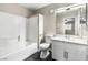 Bathroom with white tile, a tub/shower combo and single sink vanity at 8224 Crystal Star Ct, Las Vegas, NV 89145
