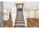 Inviting entrance with staircase, wood floors, and open access to the kitchen at 8224 Crystal Star Ct, Las Vegas, NV 89145