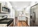 Well lit kitchen with stainless steel appliances, white cabinets and stylish countertops at 8224 Crystal Star Ct, Las Vegas, NV 89145