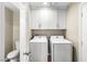 Bright laundry room featuring a washer, dryer, and convenient overhead storage at 8224 Crystal Star Ct, Las Vegas, NV 89145