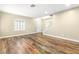 Open-concept living room with staircase, wood floors, and natural light at 8224 Crystal Star Ct, Las Vegas, NV 89145