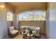 Staged Balcony with tiled floor, seating, and views of trees at 8408 Running Deer Ave # 103, Las Vegas, NV 89145