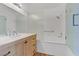 Bathroom vanity with wood cabinets, marble countertop, and shower at 8408 Running Deer Ave # 103, Las Vegas, NV 89145