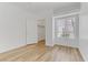 Bedroom featuring a closet, a window, wood flooring and natural light at 8408 Running Deer Ave # 103, Las Vegas, NV 89145