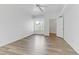 Bright bedroom features wood-look floors, ceiling fan, window, and walk in closet at 8408 Running Deer Ave # 103, Las Vegas, NV 89145