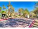 Community entrance featuring well-maintained landscaping and decorative brickwork at 8408 Running Deer Ave # 103, Las Vegas, NV 89145