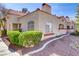 Inviting home with a red tile roof, manicured shrubs, and a lovely walkway at 8408 Running Deer Ave # 103, Las Vegas, NV 89145
