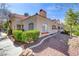 Charming single-story home with red tile roof, lush landscaping, and sidewalk at 8408 Running Deer Ave # 103, Las Vegas, NV 89145