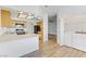 Bright kitchen featuring wood cabinets, a quartz countertop, stainless steel appliances and washer and dryer hookups at 8408 Running Deer Ave # 103, Las Vegas, NV 89145