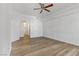 A bright living room with wood flooring, a ceiling fan, and an archway entryway at 8408 Running Deer Ave # 103, Las Vegas, NV 89145