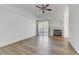 Bright living room with a fireplace, balcony, wood floors, and lots of natural light at 8408 Running Deer Ave # 103, Las Vegas, NV 89145