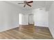 Open living room with wood floors, ceiling fan and arched doorways that lead to other rooms at 8408 Running Deer Ave # 103, Las Vegas, NV 89145