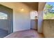 Private patio with stucco walls, tile flooring, and sliding glass doors at 8408 Running Deer Ave # 103, Las Vegas, NV 89145