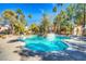 Inviting community pool surrounded by mature trees and comfortable seating at 8408 Running Deer Ave # 103, Las Vegas, NV 89145