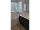 Bathroom featuring updated vanity with sink, mirror, and soaking bathtub at 9008 Cotton Rose Way, Las Vegas, NV 89134