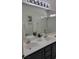 Bathroom featuring double sinks, white countertops, and a separate shower area at 9008 Cotton Rose Way, Las Vegas, NV 89134