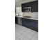 Updated kitchen featuring black cabinets, stainless steel appliances, and white countertops at 9008 Cotton Rose Way, Las Vegas, NV 89134