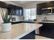 Kitchen with stainless steel appliances, dark cabinets, and a spacious white countertop at 9008 Cotton Rose Way, Las Vegas, NV 89134