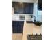 Kitchen features black cabinetry, light countertops and stainless steel sink at 9008 Cotton Rose Way, Las Vegas, NV 89134