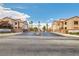 The well-maintained community features palm trees, desert landscaping, and two story condos at 9580 W Reno Ave # 211, Las Vegas, NV 89148