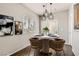 Cozy dining area with modern lighting, table set for four, and natural light at 9580 W Reno Ave # 211, Las Vegas, NV 89148
