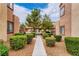 The exterior of the home features lush green shrubbery and desert landscaping at 9580 W Reno Ave # 211, Las Vegas, NV 89148