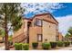 Charming two-story condo with landscaped yard and staircase leading to the front door at 9580 W Reno Ave # 211, Las Vegas, NV 89148