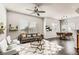 Stylishly decorated living room featuring modern furniture, rug, and natural light from large window at 9580 W Reno Ave # 211, Las Vegas, NV 89148