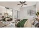 Bright bedroom with a ceiling fan, mirrored closets, and modern decor at 9580 W Reno Ave # 211, Las Vegas, NV 89148