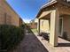Charming backyard with a covered patio, brick pavers, well-maintained landscaping, and outdoor seating at 961 Spiracle Ave, Henderson, NV 89002