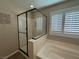 Bathroom with a glass enclosed shower and a separate bathtub at 961 Spiracle Ave, Henderson, NV 89002
