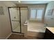Bright bathroom features a glass enclosed shower and separate soaking tub near a window with white shutters at 961 Spiracle Ave, Henderson, NV 89002