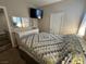 Bright bedroom with a quilt bedspread, white dresser, and a mounted television at 961 Spiracle Ave, Henderson, NV 89002