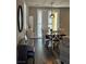 Dining area with a wooden table, chandelier, piano, and sliding glass doors at 961 Spiracle Ave, Henderson, NV 89002