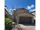 Two-story home with a two-car garage, landscaped yard, and stone driveway on a sunny day at 961 Spiracle Ave, Henderson, NV 89002