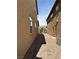 Exterior walkway between two homes features desert landscaping with a rock and brick pathway at 961 Spiracle Ave, Henderson, NV 89002
