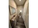 Hallway features wood-look flooring, neutral walls, and a decorative mirror above a built-in storage console at 961 Spiracle Ave, Henderson, NV 89002