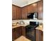 A kitchen with dark cabinets, granite countertops, and stainless steel appliances at 961 Spiracle Ave, Henderson, NV 89002