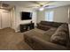 Spacious living area with carpet, a ceiling fan and comfortable seating, plus a television at 961 Spiracle Ave, Henderson, NV 89002