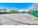 Outdoor hockey court with smooth surface, surrounded by green fencing and mature trees under a bright blue sky at 10479 Garden Light Dr, Las Vegas, NV 89135