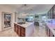 Spacious kitchen island featuring a modern cooktop with seating and seamless access to the living room at 10479 Garden Light Dr, Las Vegas, NV 89135