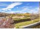 Balcony view showcases a neighborhood landscape with mountains against a blue cloudy sky at 11298 Merado Peak Dr, Las Vegas, NV 89135