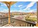 Balcony view of a well-maintained neighborhood landscape against a blue cloudy sky at 11298 Merado Peak Dr, Las Vegas, NV 89135